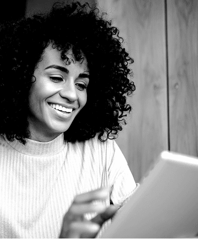 Smiling woman using digital tablet indoors